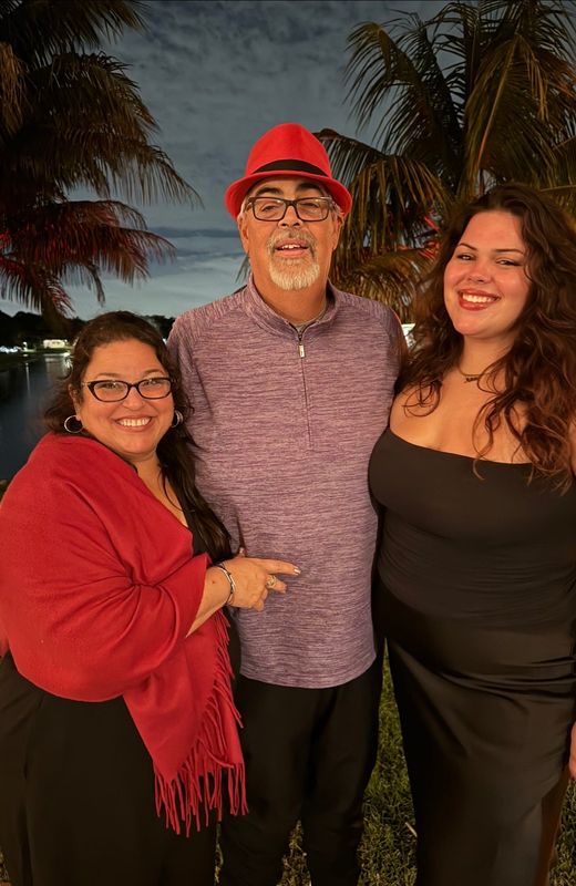 Robert Morales, center, with his wife and daughter.