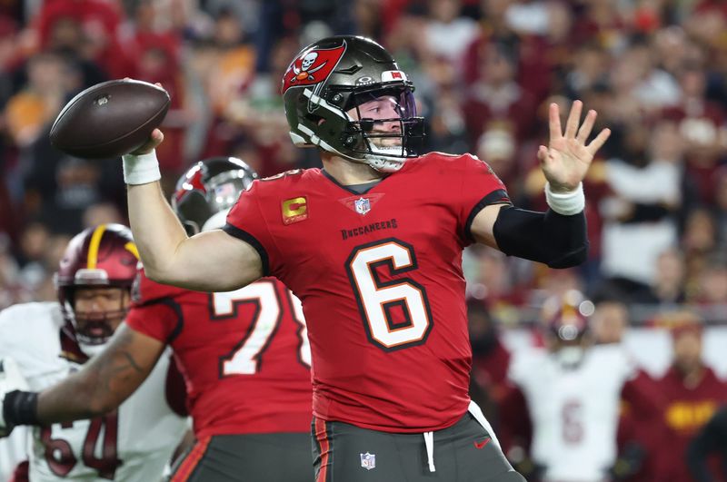 Jan 12, 2025; Tampa, Florida, USA; Tampa Bay Buccaneers quarterback Baker Mayfield (6) throws during the second quarter of a NFC wild card playoff against the Washington Commanders at Raymond James Stadium. Mandatory Credit: Kim Klement Neitzel-Imagn Images