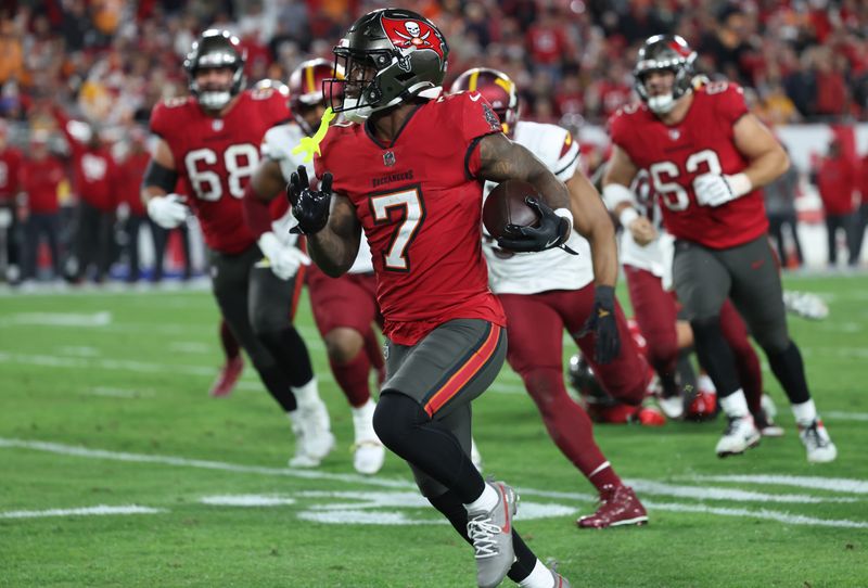 Jan 12, 2025; Tampa, Florida, USA; Tampa Bay Buccaneers running back Bucky Irving (7) runs during the third quarter of a NFC wild card playoff against the Washington Commanders at Raymond James Stadium. Mandatory Credit: Kim Klement Neitzel-Imagn Images