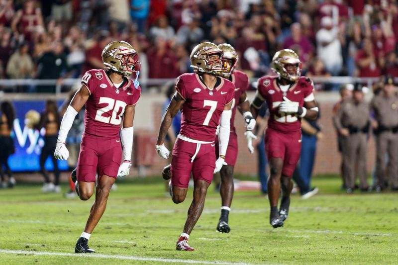 Nov 18, 2023; Tallahassee, Florida, USA; Florida State Seminoles defensive back Azareye'h Thomas (20) and defensive back Jarrian Jones (7) celebrate an interception against the North Alabama Lions during the third quarter at Doak S. Campbell Stadium. Mandatory Credit: Morgan Tencza-USA TODAY Sports