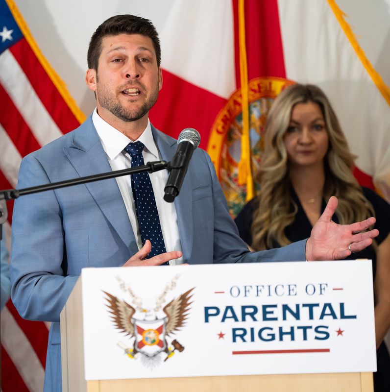 Florida Attorney General James Uthmeier, center, spoke about the establishment of the Office of Parental Rights in the Attorney General’s Office at a press conference held at the Jacksonville Classical Academy Tuesday morning, April 29, 2025 in Jacksonville, Fla. Uthmeier said that the new office will protect parent’s rights. “We want to make sure that parents are involved in (growing up, education, health care choices and curriculum for their children). “It is not the role of the government to raise kids. That role is reserved, that is God given right to given to parents.,” Uthmeier said. Uthmeier was flanked by January Littlejohn, a mother and parent’s right activist, right. [Doug Engle/Florida Times-Union]