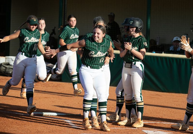Trinity Catholic celebrates Trinity Catholic Caylee Barbe (33) three run homer in the second during the 2025 2A District 6 FHSAA Softball District Tournaments at Trinity Catholic High School in Ocala, FL on Wednesday, April 30, 2025. Trinity won 10-0 [Alan Youngblood/Ocala Star-Banner]