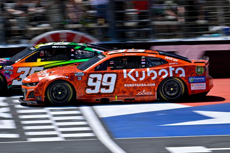 May 4, 2025; Fort Worth, Texas, USA; NASCAR Cup Series driver Daniel Suarez (99) drives during the Wurth 400 race at Texas Motor Speedway. Mandatory Credit: Jerome Miron-Imagn Images