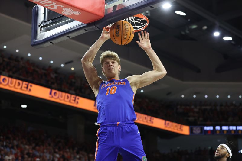 Florida Gators forward Thomas Haugh (10) makes a dunk against Auburn. Florida is reportedly planning a college basketball game against Miami in Jacksonville in the 2025-26 season.
