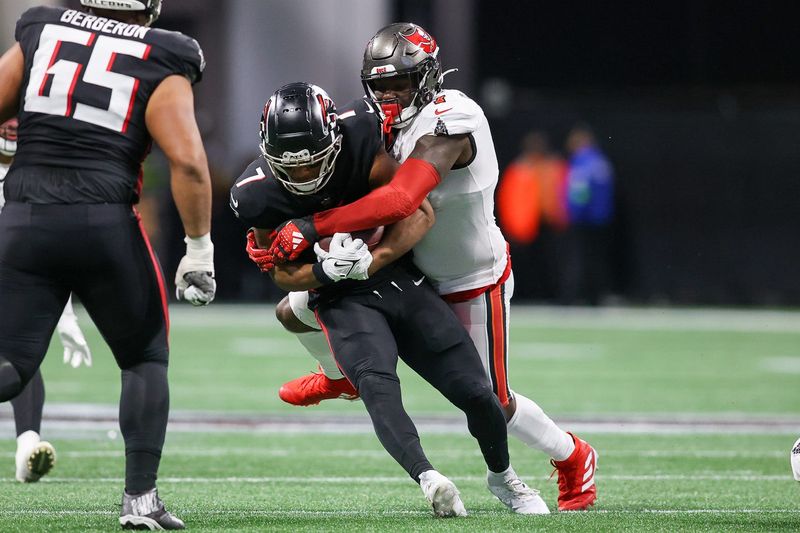 Dec 10, 2023; Atlanta, Georgia, USA; Tampa Bay Buccaneers linebacker Shaquil Barrett (7) tackles Atlanta Falcons running back Bijan Robinson (7) in the first half at Mercedes-Benz Stadium. Mandatory Credit: Brett Davis-USA TODAY Sports