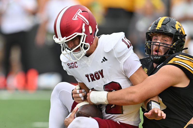 Sep 14, 2024; Iowa City, Iowa, USA; Iowa Hawkeyes defensive lineman Max Llewellyn (48) sacks Troy Trojans quarterback Matthew Caldwell (12) during the third quarter at Kinnick Stadium. Mandatory Credit: Jeffrey Becker-Imagn Images