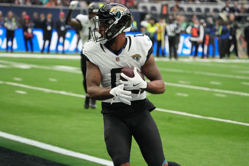 Oct 13, 2024; London, United Kingdom; Jacksonville Jaguars wide receiver Gabe Davis (0) catches a 21-yard touchdown pass against the Chicago Bears in the second half during an NFL International Series game at Tottenham Hotspur Stadium. Mandatory Credit: Kirby Lee-Imagn Images