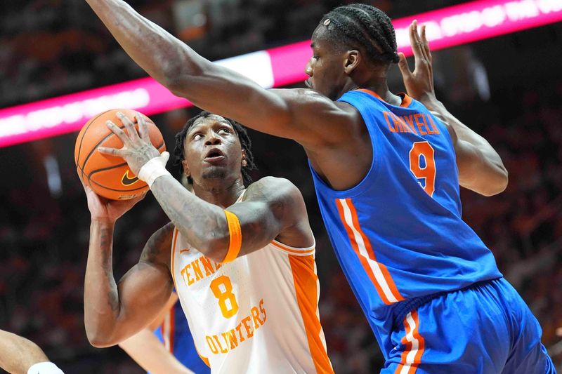 Tennessee's Darlinstone Dubar (8) is defended by Florida's Rueben Chinyelu (9) during an NCAA college basketball game between Tennessee and Florida in Knoxville, Tenn., Saturday, Feb. 1, 2025.
