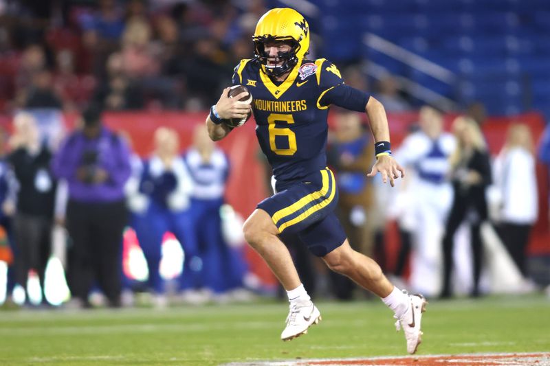 Dec 17, 2024; Frisco, TX, USA; West Virginia Mountaineers quarterback Garrett Greene (6) runs for a touchdown against the Memphis Tigers in the second quarter at Toyota Stadium. Mandatory Credit: Tim Heitman-Imagn Images