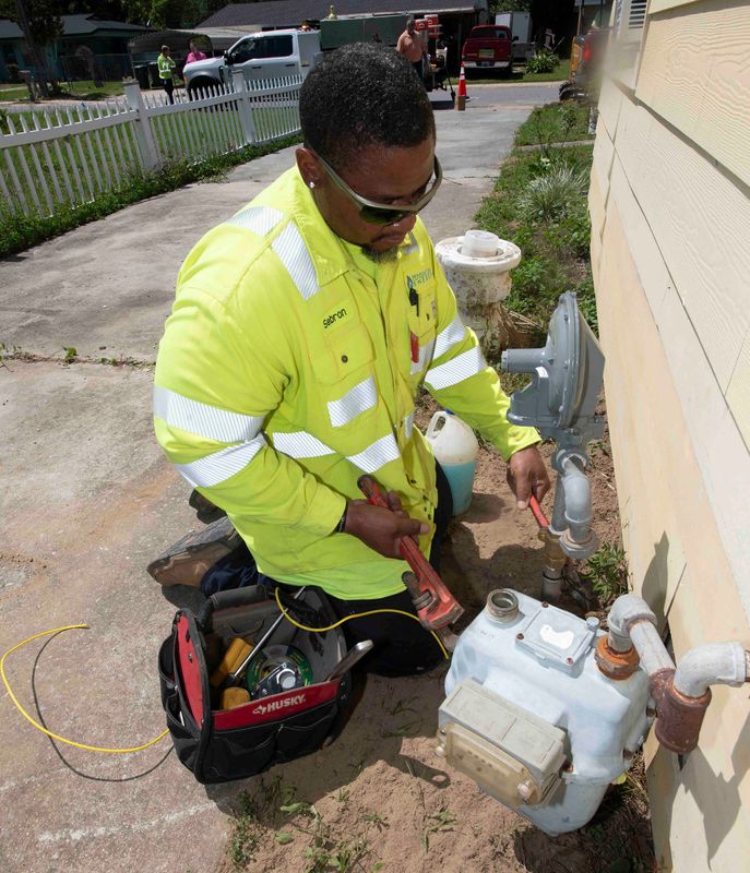 Pensacola Energy employee Sabron Ailkens reconnects the gas service to a home in the Rolling Hills neighborhood on May 15, 2025. The gas company field crews are working to upgrade the old, outdated gas lines and connect the neighborhood.