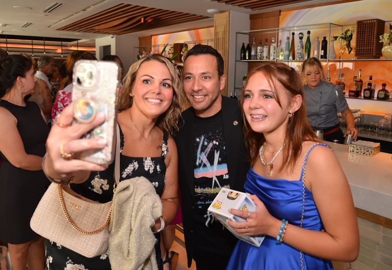 Howie D takes a picture with fans at the grand opening of COA restaurant in May 2025.