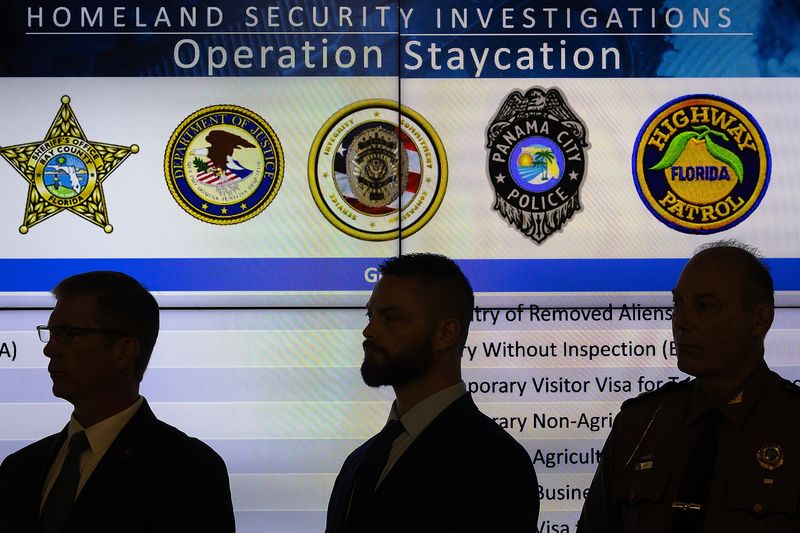 Law enforcement officers are seen at the Bay County Sheriff’s Office in Panama City, Fla., May 16, 2025. Tommy Ford, Bay County's sheriff, delivered remarks about the recent Operation Staycation. The two-day immigration operation netted 18 visa violators in Bay County, and three in nearby Leon County. Also in attendance: Homeland Security Investigations Panama City; Enforcement and Removal Operations Miami-Tallahasee Field Office; U.S. Department of Justice; Panama City Beach Police Department; Florida Highway Patrol; Panama City Police Department; and the Florida Department of Law Enforcement. (Tyler Orsburn/News Herald)