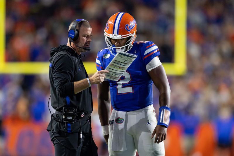Oct 19, 2024; Gainesville, Florida, USA; Florida Gators head coach Billy Napier and Florida Gators quarterback DJ Lagway (2) review a play against the Kentucky Wildcats during the second half at Ben Hill Griffin Stadium. Mandatory Credit: Matt Pendleton-Imagn Images