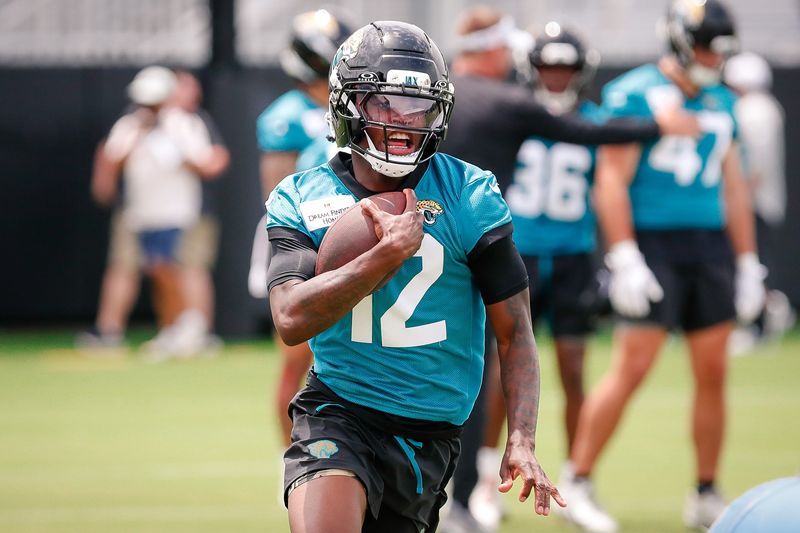 May 10, 2025; Jacksonville, FL, USA; Jacksonville Jaguars wide receiver Travis Hunter (12) runs after completing a passing drill during rookie minicamp at Miller Electric Center. Mandatory Credit: Travis Register-Imagn Images