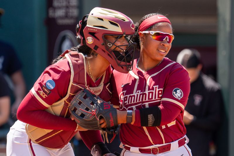 Florida State Seminoles catcher Michaela Edenfield (51) and infielder Jaysoni Beachum (42) talk before an inning. The Texas Tech Red Raiders defeated the Florida State Seminoles 2-1 in the NCAA WCWS Super Regionals on Friday, May 23, 2025.