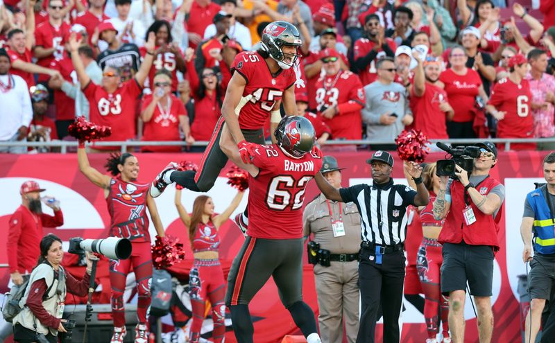Dec 8, 2024; Tampa, Florida, USA; Tampa Bay Buccaneers wide receiver Jalen McMillan (15) celebrates with center Graham Barton (62) after he scored a touchdown against the Las Vegas Raiders during the second half at Raymond James Stadium. Mandatory Credit: Kim Klement Neitzel-Imagn Images