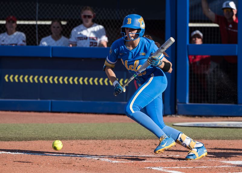May 31, 2025; Oklahoma City, OK, USA; UCLA Bruins outfielder Rylee Slimp (29) lays down a bunt in the second inning against the Texas Tech Red Raiders during the NCAA Softball Women's College World Series at Devon Park. Mandatory Credit: Brett Rojo-Imagn Images