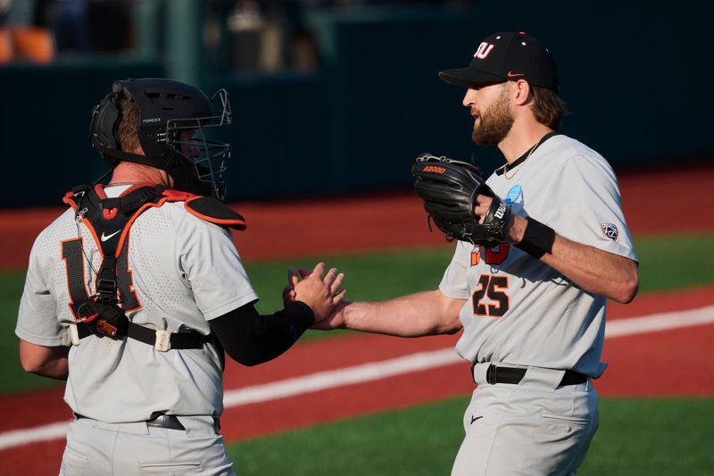 Jun 1, 2025; Corvallis, OR, USA; Oregon St. catcher Bryce Hubbard (14) congratulates pitcher Joey Mundt (25) after a game against Saint Mary's at the NCAA Corvallis Regional at Goss Stadium. Mandatory Credit: Troy Wayrynen-Imagn Images