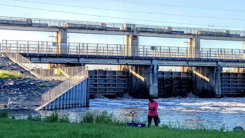 A woman prepares her fishing line by the Rodman Dam in the Ocala National Forest, Putnam County, Florida.