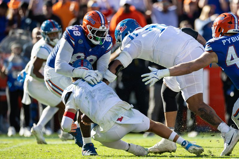 Nov 23, 2024; Gainesville, Florida, USA; Florida Gators defensive lineman Caleb Banks (88) sacks Mississippi Rebels quarterback Jaxson Dart (2) during the second half at Ben Hill Griffin Stadium. Mandatory Credit: Matt Pendleton-Imagn Images