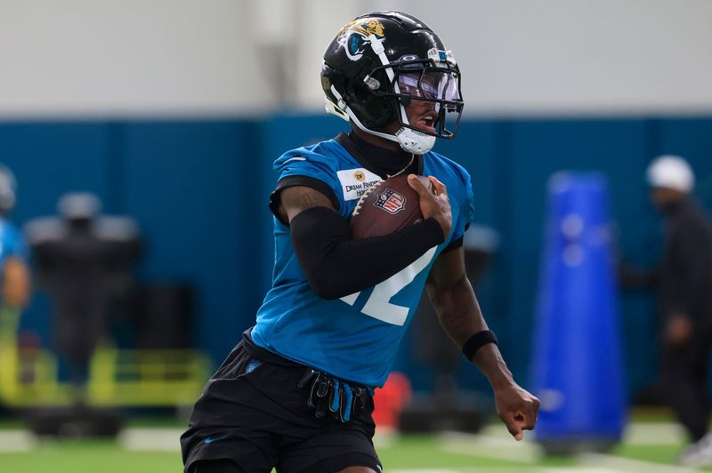 Jacksonville Jaguars wide receiver Travis Hunter (12) runs the ball during the 10th organized team activity at Miller Electric Center Wednesday, June 4, 2025 in Jacksonville, Fla. [Corey Perrine/Florida Times-Union]