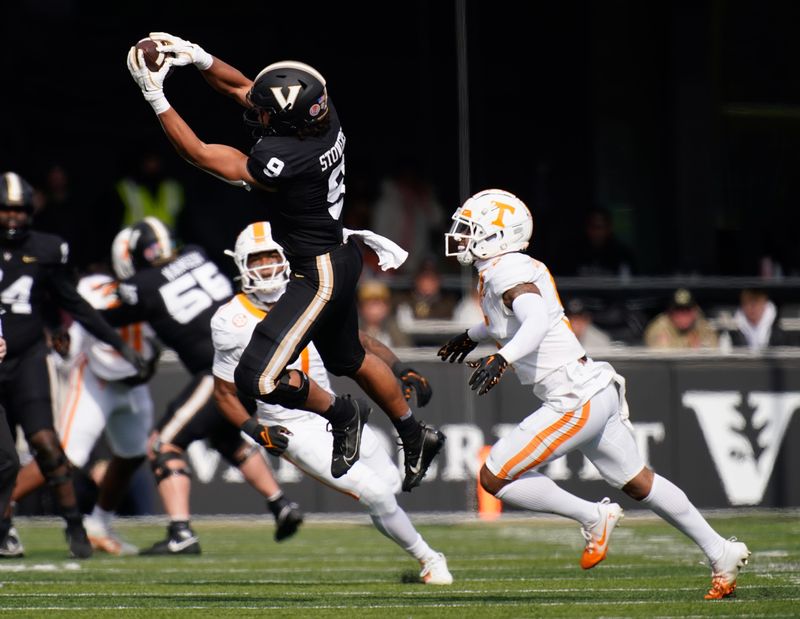 Vanderbilt tight end Eli Stowers (9) pulls down a pass in front of Tennessee defensive back Christian Harrison (5) during the first quarter at FirstBank Stadium in Nashville, Tenn., Saturday, Nov. 30, 2024.