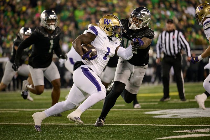 Nov 30, 2024; Eugene, Oregon, USA; Washington Huskies running back Jonah Coleman (1) carries the ball during the first half against Oregon Ducks defensive end Matayo Uiagalelei (10) at Autzen Stadium. Mandatory Credit: Troy Wayrynen-Imagn Images