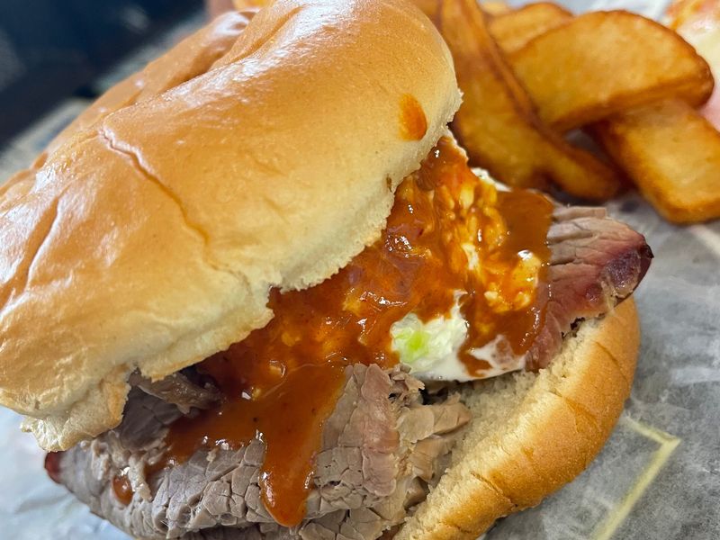 Sliced beef sandwich topped with coleslaw and homemade barbecue sauce at Dale's Bar-B-Q in Fort Pierce