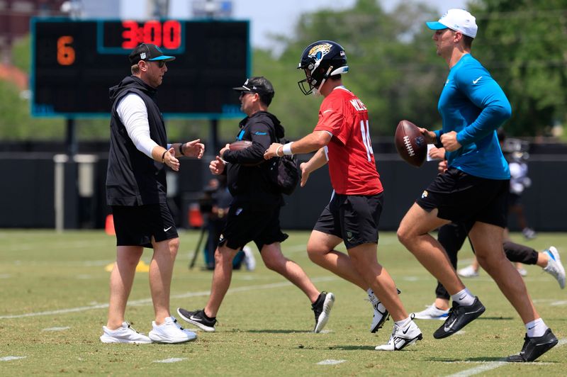 Jacksonville Jaguars head coach Liam Coen greets quarterback Nick Mullens (12) during the first organized team activity at Miller Electric Center Monday, May 19, 2025 in Jacksonville, Fla.