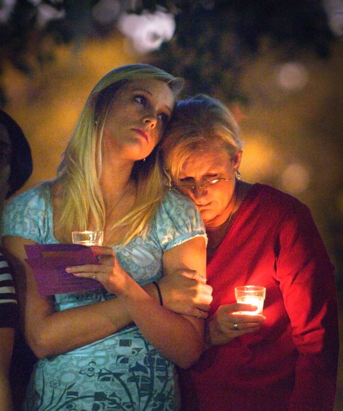 Jessie Clifton, left, and her mother Sheila Clifton Delongis, sister and mother of 1998 murder victim Maddie Clifton, stand in silence during a candlelight vigil on Oct. 20, 2008, in tribute to children lost to violence in Jacksonville.