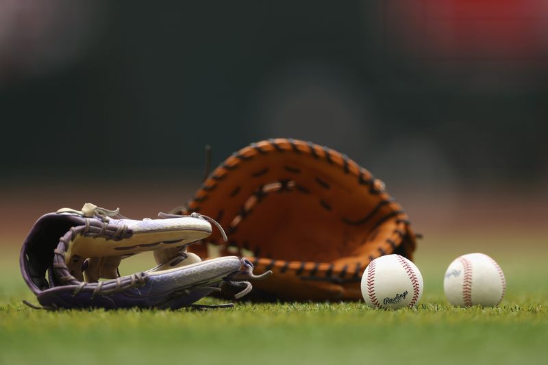 PHOENIX, ARIZONA - MAY 17: Detail of gloves and baseballs on the field during the MLB game at Chase Field on May 17, 2025 in Phoenix, Arizona. (Photo by Christian Petersen/Getty Images)