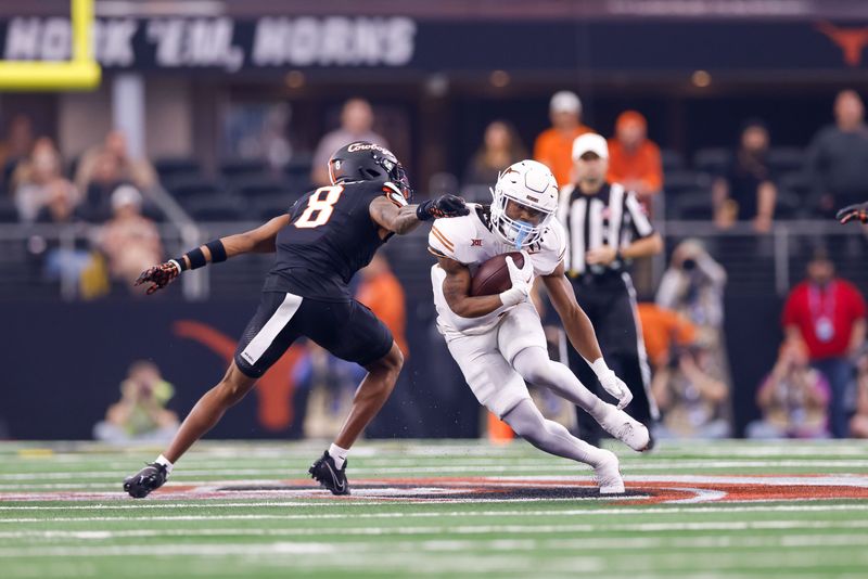 Dec 2, 2023; Arlington, TX, USA; Texas Longhorns running back Jaydon Blue (23) and Oklahoma State Cowboys cornerback D.J. McKinney (8) during the first quarter at AT&T Stadium. Mandatory Credit: Andrew Dieb-USA TODAY Sports