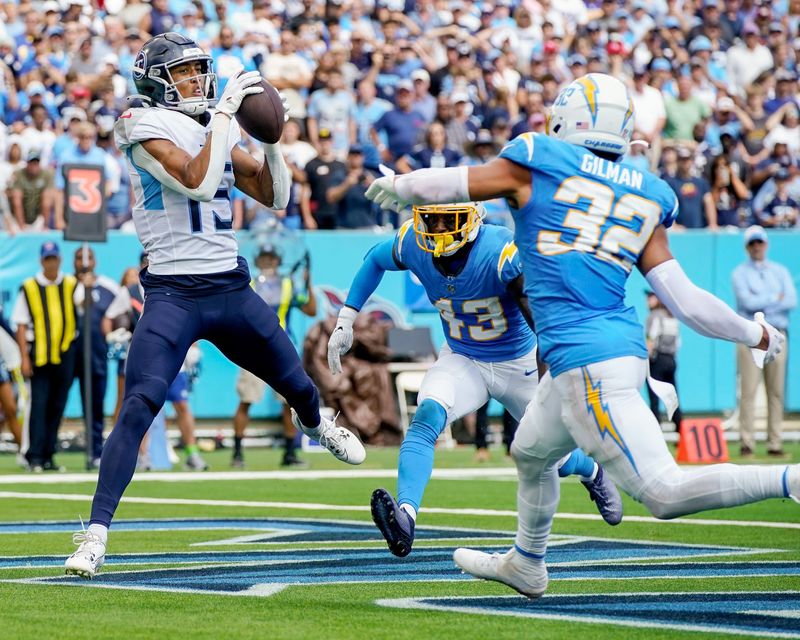 Tennessee Titans wide receiver Nick Westbrook-Ikhine (15) brings in a touchdown past Los Angeles Chargers cornerback Michael Davis (43) and safety Alohi Gilman (32) at Nissan Stadium in Nashville on Sept. 17, 2023. The Titans won their home opener 27-24 in overtime.
