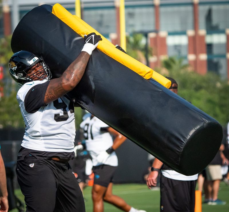 Jacksonville Jaguars defensive tackle Maason Smith (94) wraps up a tackling dummy during drills during the seventh organized team activity at the Miller Electric Center in Jacksonville, Fla. Monday, June 2, 2025. [Doug Engle/Florida Times-Union]