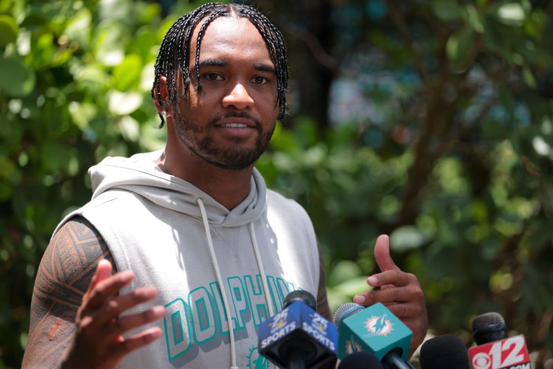 Jun 10, 2025; Miami, FL, USA; Miami Dolphins quarterback Tua Tagovailoa (1) speaks to reporters after practicing during mandatory minicamp at Hard Rock Stadium. Mandatory Credit: Sam Navarro-Imagn Images
