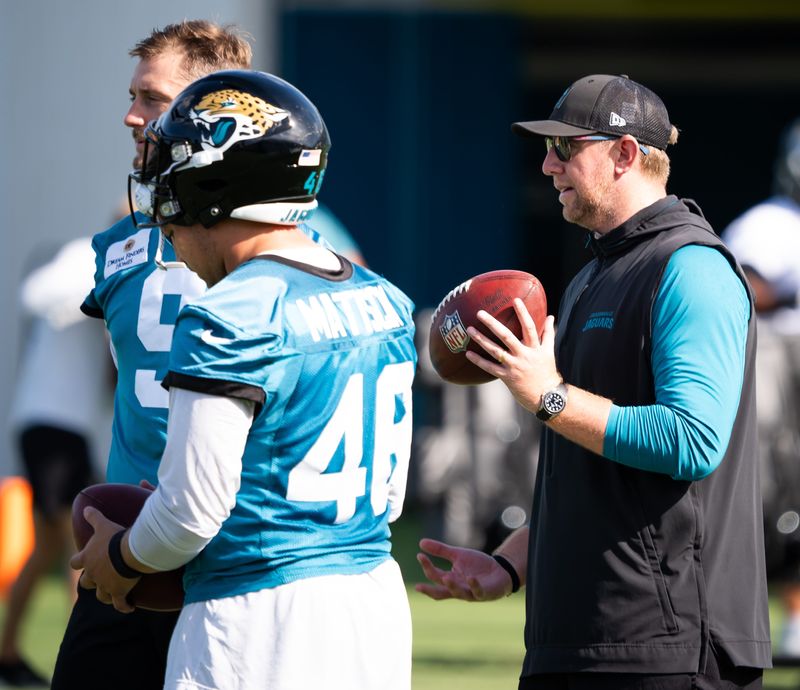 Jacksonville Jaguars head coach Liam Coen talks with teammates Jacksonville Jaguars punter Logan Cooke (9) and Jacksonville Jaguars long snapper Ross Matiscik (46) during the Jacksonville Jaguars’ third mandatory minicamp Thursday June 12, 2025 at the Miller Electric Center in Jacksonville, Fla. [Doug Engle/Florida Times-Union]