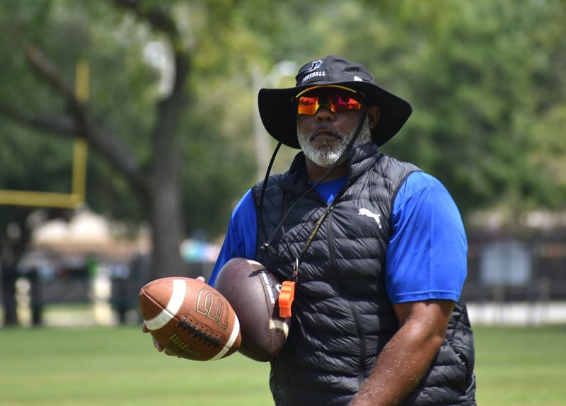 E.G. Green is the head football coach of the Destin High Sharks.