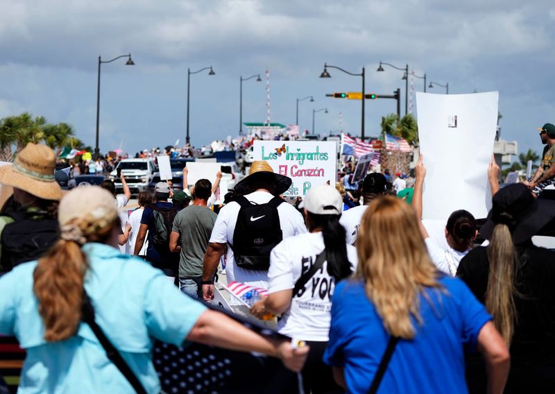 Demonstrators participating in “No Kings National Day of Defiance" gather along the Southern Boulevard Bridge near the Mar-a-Lago Club on June 14 in Palm Beach.