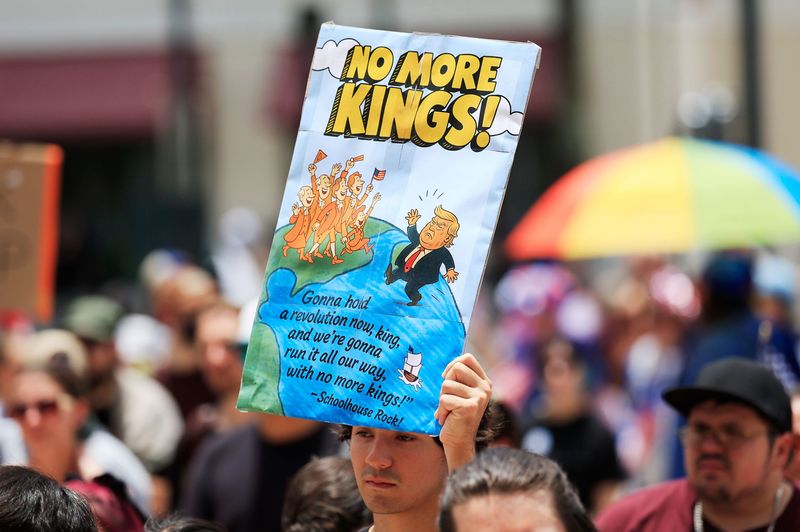 Justin Lopez hold up sign during a “No Kings” protest outside the Duval County Courthouse Saturday, June 14, 2025 in Jacksonville, Fla. People took part of one of nearly 2,000 nationwide rallies against Trump and his administration. [Corey Perrine/Florida Times-Union]