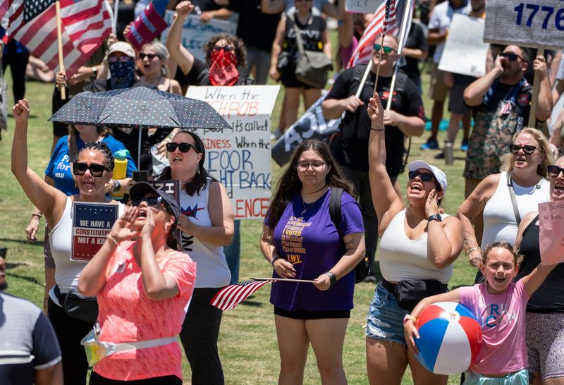 Protesters rally at the Meyer Amphitheatre during a "No Kings Day" protest on June 14, 2025 in West Palm Beach, Florida.