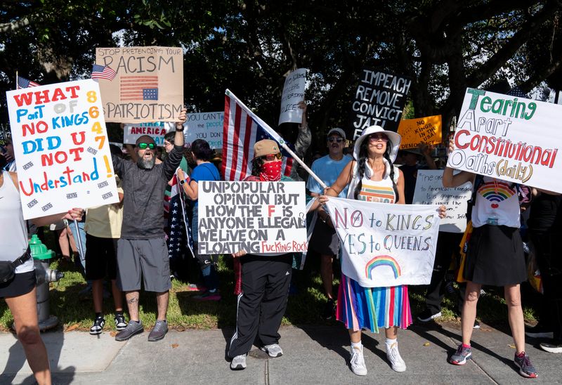 Protesters hold signs and chant at Phipps Park before marching during a "No Kings Day" protest on June 14, 2025 in West Palm Beach, Florida.