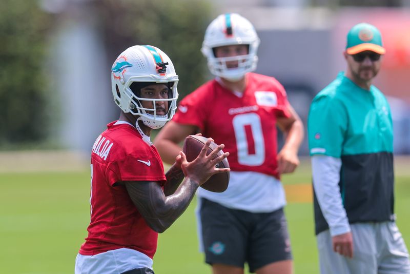 Jun 10, 2025; Miami, FL, USA; Miami Dolphins quarterback Tua Tagovailoa (1) throws the football during mandatory minicamp at Hard Rock Stadium. Mandatory Credit: Sam Navarro-Imagn Images