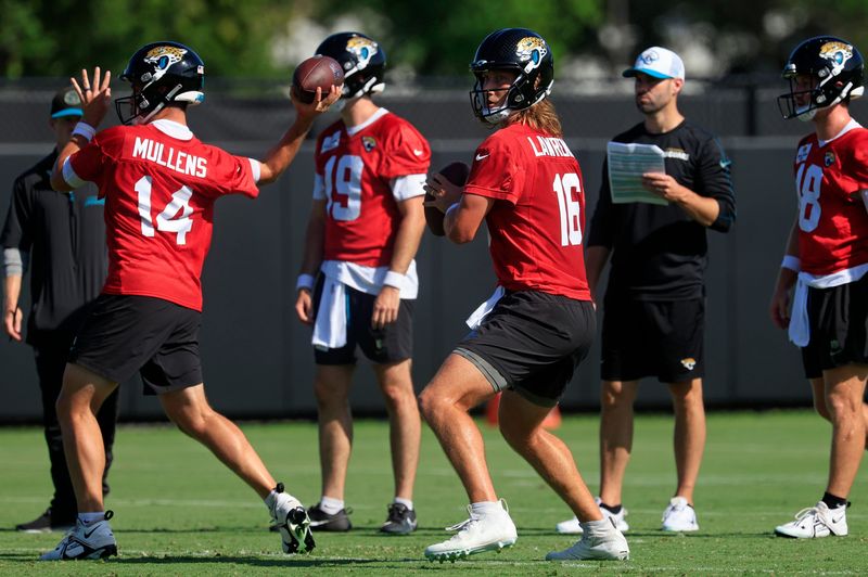 Jacksonville Jaguars quarterback Trevor Lawrence (16), center, looks to pass near quarterbacks Nick Mullens (14), from left, Seth Henigan (19), and John Wolford (18) during the second mandatory minicamp at Miller Electric Center Wednesday, June 11, 2025 in Jacksonville, Fla.