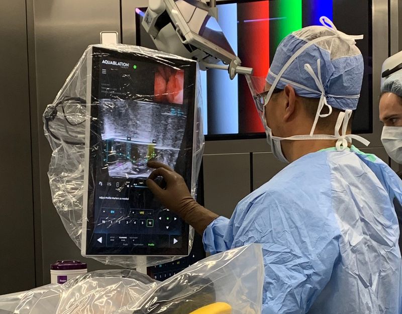 Dr. Ramsay Kuo, a urologist with First Physicians Group, uses the new Hydros Robotics System to treat an enlarged prostate earlier in June at Sarasota Memorial Hospital.