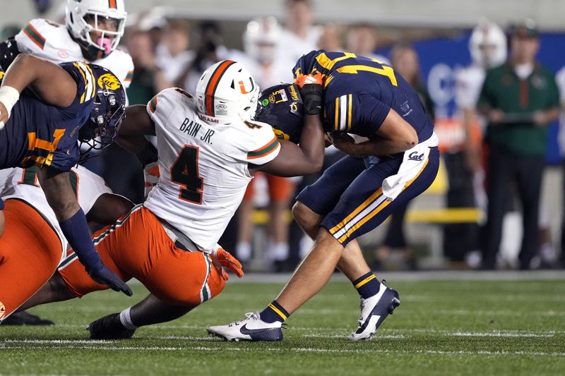 Oct 5, 2024; Berkeley, California, USA; Miami Hurricanes defensive lineman Rueben Bain Jr. (4) sacks California Golden Bears quarterback Fernando Mendoza (right) during the fourth quarter at California Memorial Stadium. Mandatory Credit: Darren Yamashita-Imagn Images