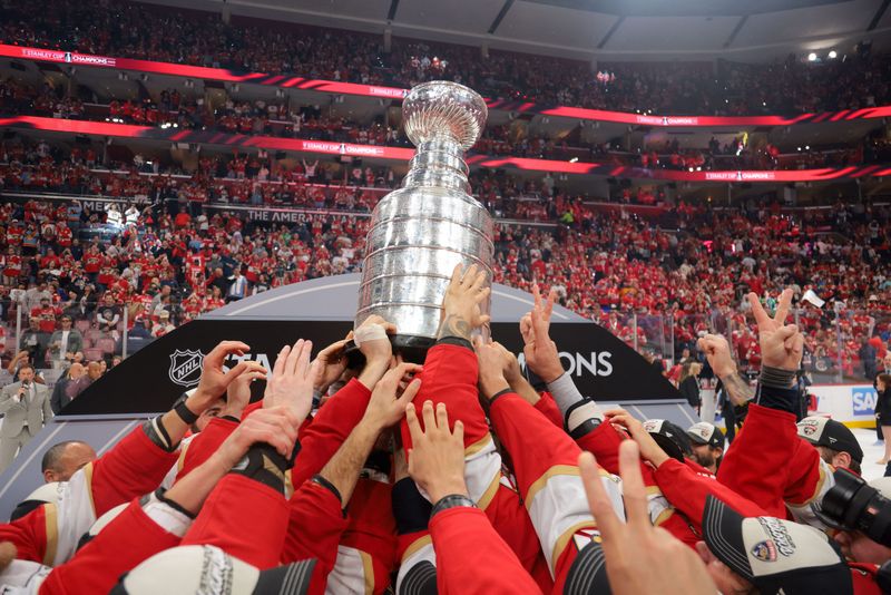 Jun 17, 2025; Sunrise, Florida, USA; The Florida Panthers hoist the Stanley Cup after winning game six of the 2025 Stanley Cup Final against the Edmonton Oilers at Amerant Bank Arena. Mandatory Credit: Sam Navarro-Imagn Images