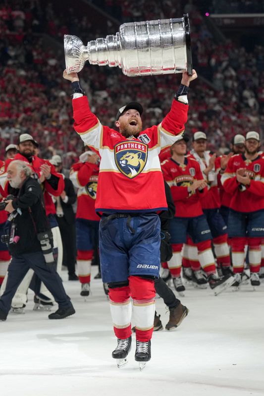 Florida Panthers center Sam Bennett hoists the Stanley Cup after winning Game 6 of the 2025 Stanley Cup Final at Amerant Bank Arena on June 17, 2025 in Sunrise, Florida.
