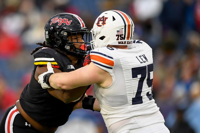 Dec 30, 2023; Nashville, TN, USA; Maryland Terrapins defensive lineman Christian Teague (91) rushes as Auburn Tigers offensive lineman Connor Lew (75) defends during the second half at Nissan Stadium. Mandatory Credit: Steve Roberts-USA TODAY Sports