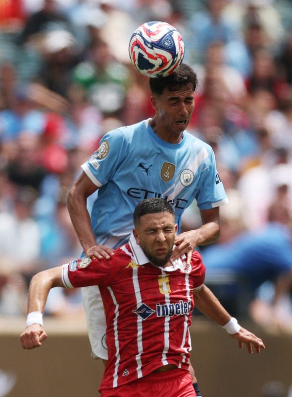 June 18: Manchester City's Vitor Reis (22) climbs over Wydad AC's Mohamed Rayhi for a header at Lincoln Financial Field. Man City won the game, 2-0.