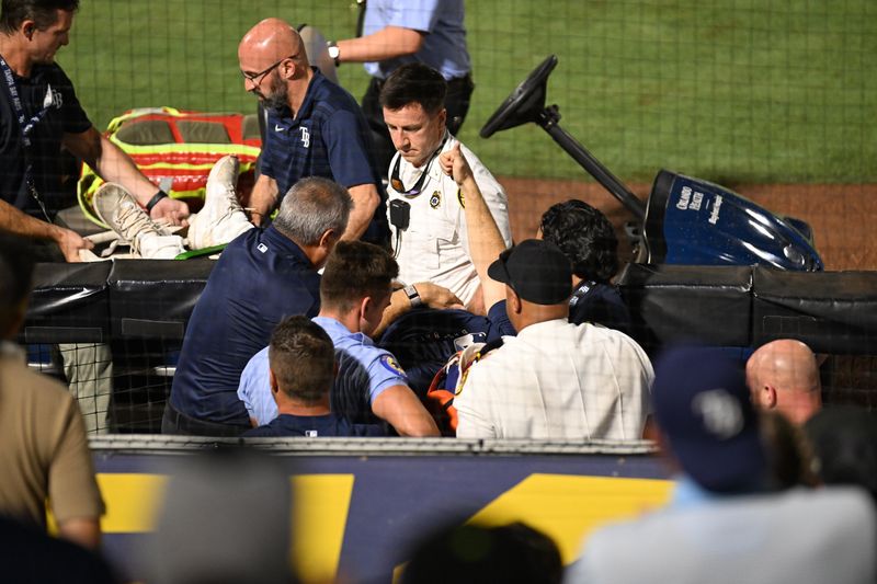 Tampa Bay Rays pitcher Hunter Bigge (43) gets medical attention after getting hit in the face by a foul ball.